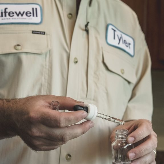 Lifewell master plumber Tyler Gilmore running an in-home water test